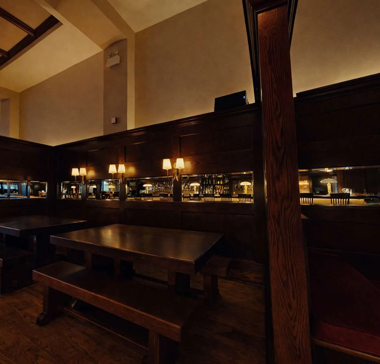 Communal wooden tables and benches in the main bar at The Gingerman